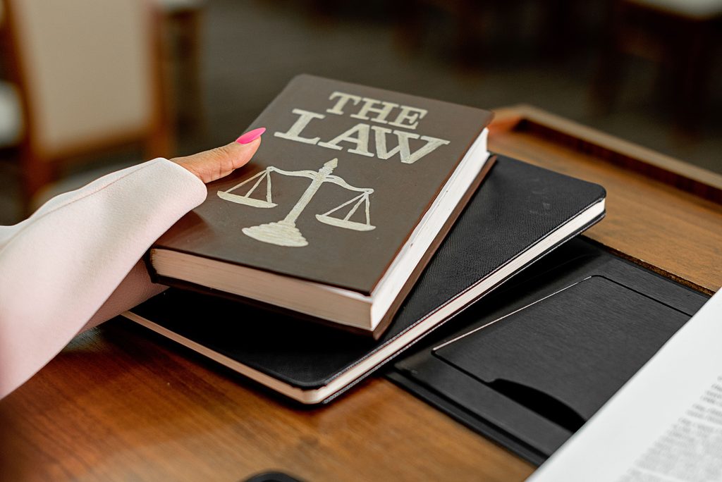 Law book and scales of justice on a desk